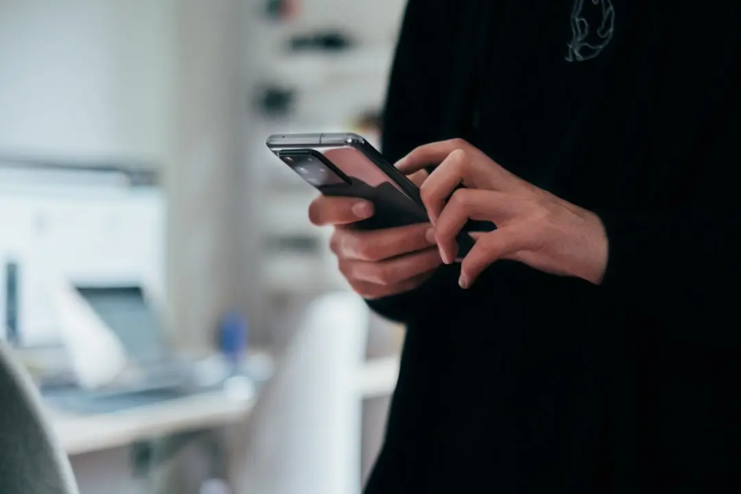 Close-up of a person's hands holding a phone
