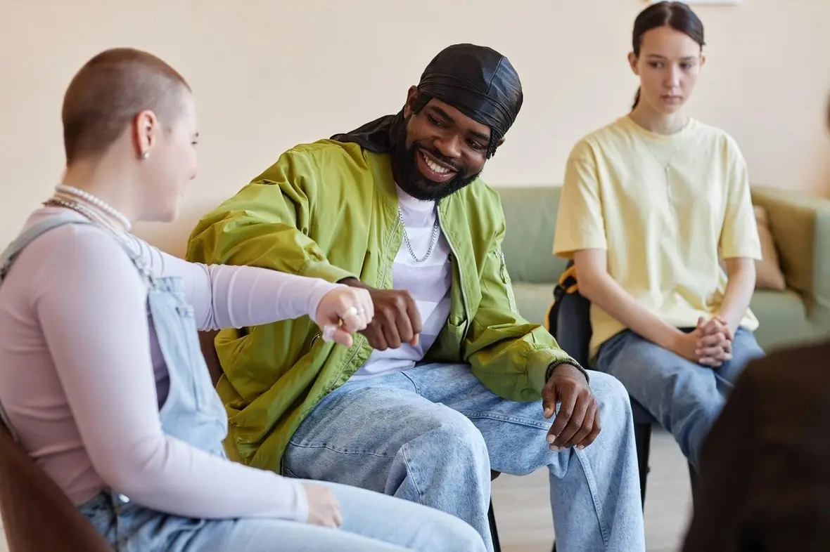 A group of young people sitting together, talking