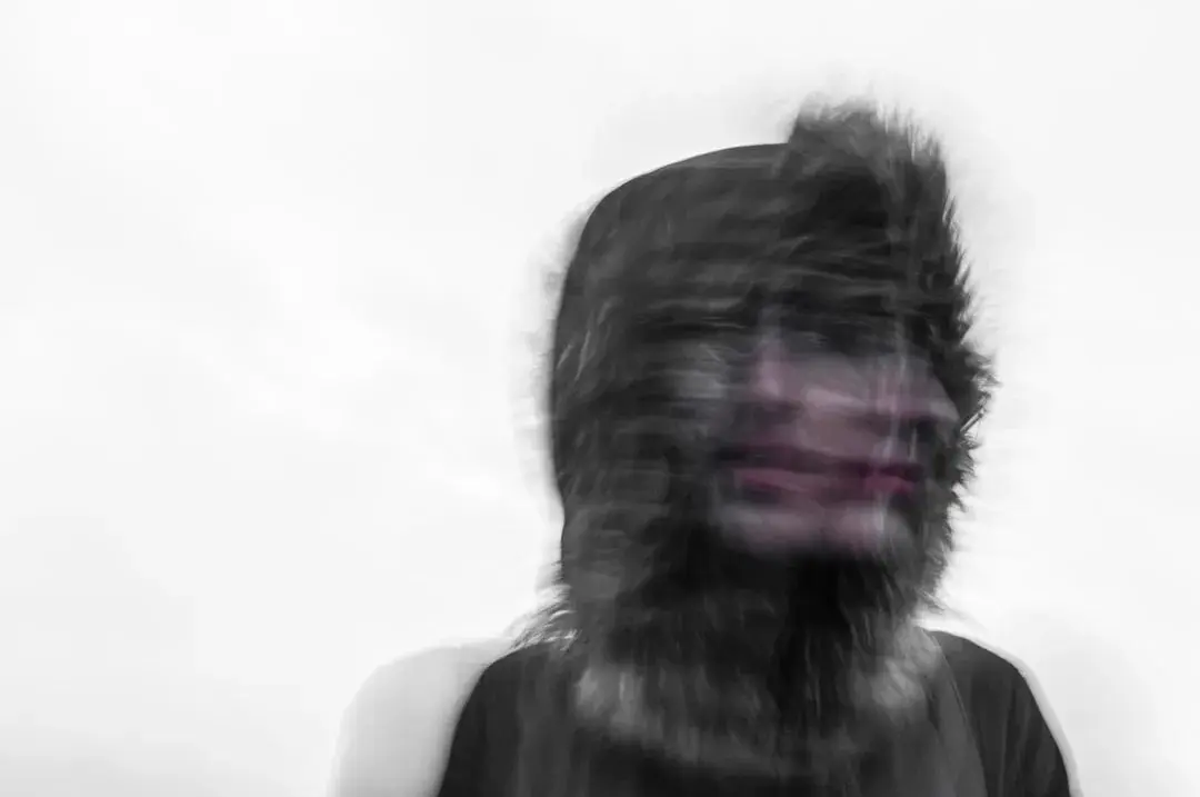 A blurred black and white portrait of a person